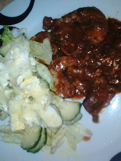 A picture of Chillies chicken gizzards & necks served with green salad.