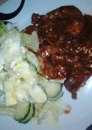 A picture of Chillies chicken gizzards & necks served with green salad.