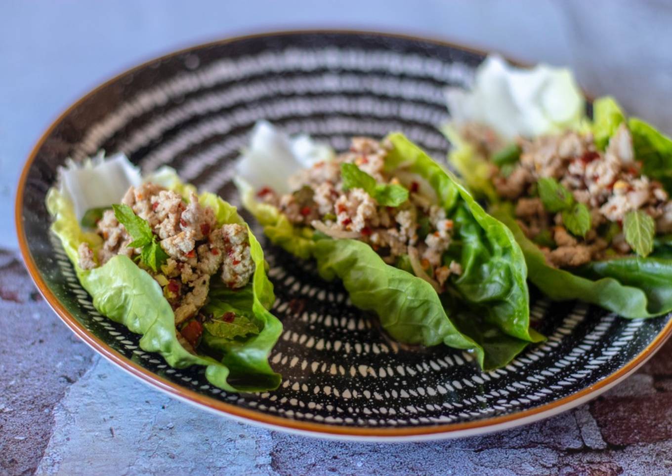 Larb chicken in lettuce cups