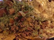 A picture of nachos with cheese dip