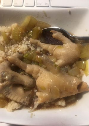 A picture of Chicken leg soup with peanuts and celery.