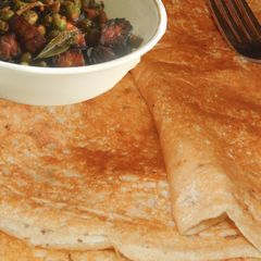A picture of Curry Dosai: Crispy Jowar dosa paired with flavorful spicy rich curry.