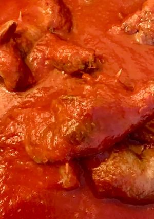 A picture of Stuffed Horse Braciole Cooked in Tomato Sauce.