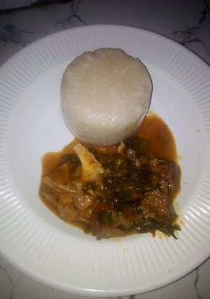 A picture of Eba with bitter leaf soup.