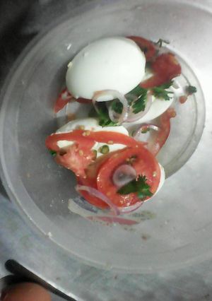 A picture of Boiled eggs with kachumbari.