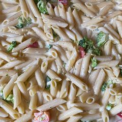 A picture of Penne pasta in white sauce.