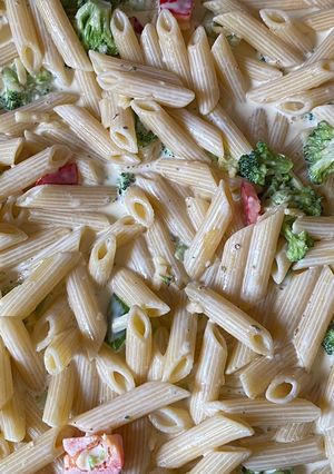 A picture of Penne pasta in white sauce.
