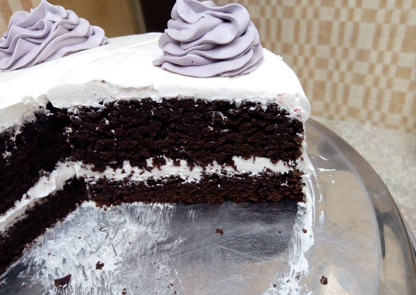 Whipped cream frosted chocolate cake