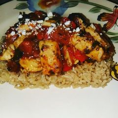 A picture of Chicken Florentine over Brown rice.