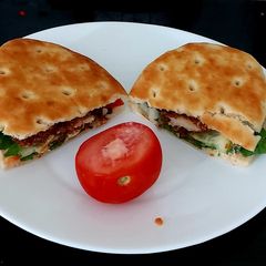 A picture of My Buttermilk coated chicken on Soft Focaccia Bread with Salad.