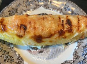 Foto principal de Plátano macho maduro o bananas rellenas de carne cubiertas de queso