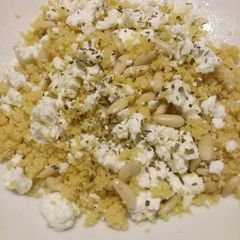 A picture of Cous cous salad with feta cheese and pine nuts.