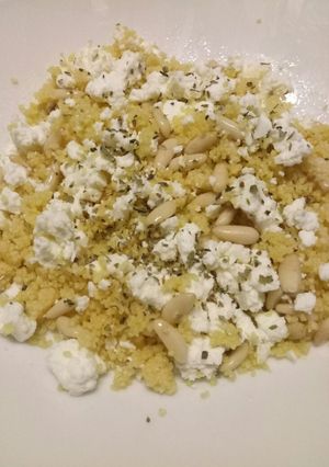 A picture of Cous cous salad with feta cheese and pine nuts.