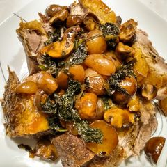 A picture of One pan roasted pork, potatoes, mushrooms, kale and pan gravy.