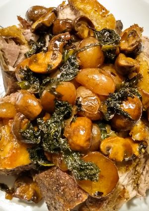 A picture of One pan roasted pork, potatoes, mushrooms, kale and pan gravy.