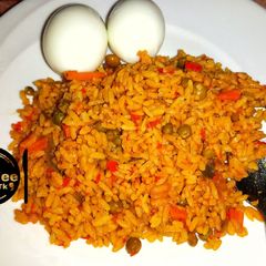 Jallof rice with cooked eggs A picture of Jallof rice with cooked eggs.