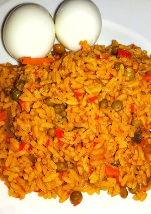 A picture of Jallof rice with cooked eggs.