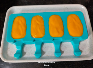 A picture of Kesar Mango Yogurt Popsicles.