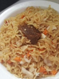 A picture of Indomine with carrots,cabbage and meat.