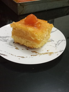 صورة لوصفة بسبوسة بحشوة كريمة البرتقال 🍊