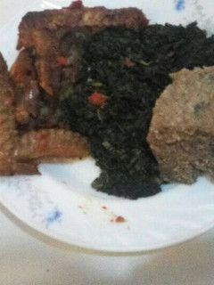 A picture of Brown ugali greens and chicken.