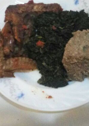 A picture of Brown ugali greens and chicken.
