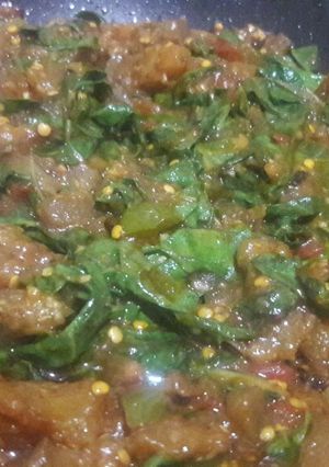 A picture of Eggplant with baby Spinach.