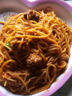 A picture of Spagetti with green pepper.