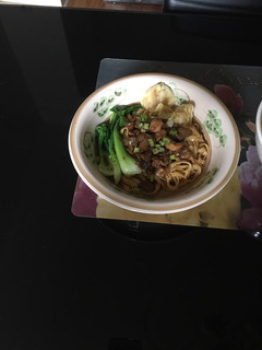 A picture of Chicken mushroom noodle with wonton.