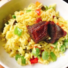 A picture of Fried rice and fried beef.