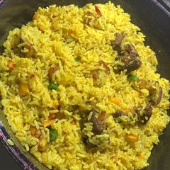 A picture of Fish and plantain fried rice.