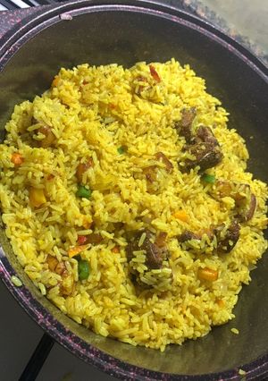 A picture of Fish and plantain fried rice.