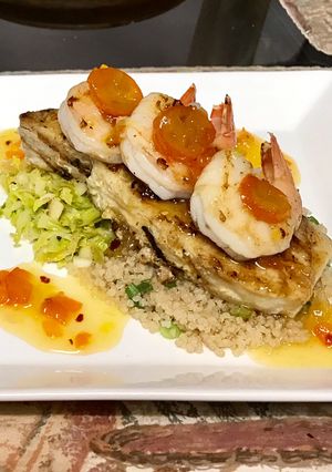 A picture of Grilled halibut and shrimp kumquat chutney, shaved Brussels sprouts,And quinoa.