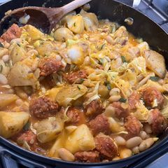 A picture of Chorizo, potatoes, beans, courgette and cabbage.