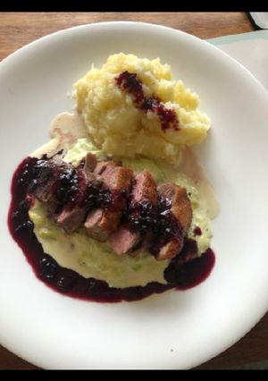 A picture of Duck with mash, creamy leak and red wine jus.
