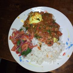 A picture of Spicy egg curry and cumin rice.