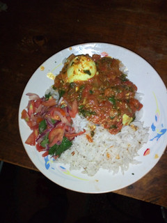 A picture of Spicy egg curry and cumin rice.