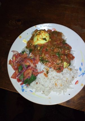 A picture of Spicy egg curry and cumin rice.