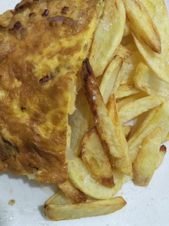 A picture of Fried eggs with chips.