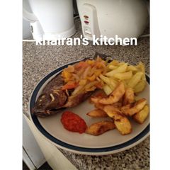 Chips,plantain and grilled tilapia fish A picture of Chips,plantain and grilled tilapia fish.