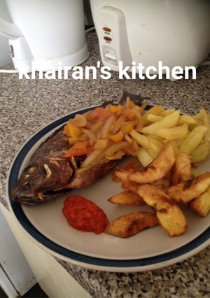 A picture of Chips,plantain and grilled tilapia fish.