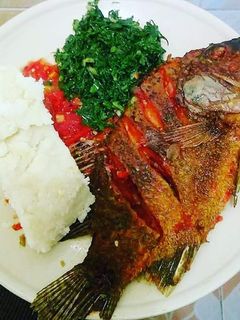 A picture of Fried Fish, Kales with Ugali.