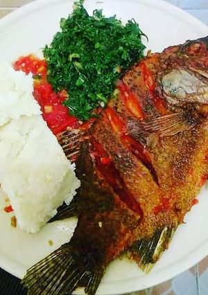 A picture of Fried Fish, Kales with Ugali.