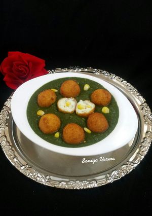 A picture of Golden balls in green gravy.