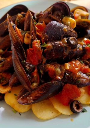 Una foto de Mejillones a la puttanesca con patatas fritas