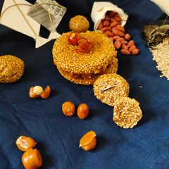 A picture of Chikki cake and sesame ladoos.