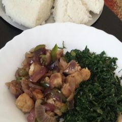 A picture of Fried pork with greens.