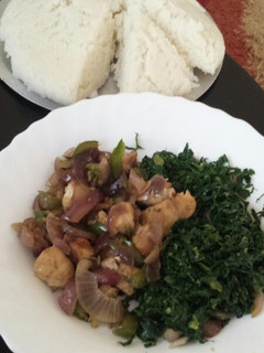 A picture of Fried pork with greens.