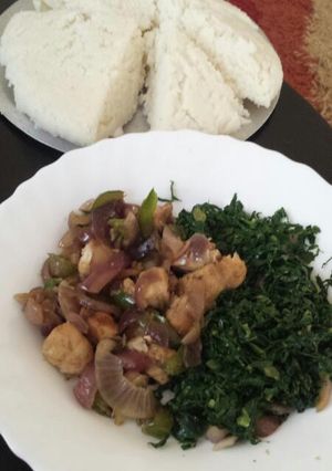 A picture of Fried pork with greens.