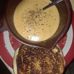 A picture of Cheese Bacon Broccoli Soup with Grilled Turkey Muenster Sandwich.
